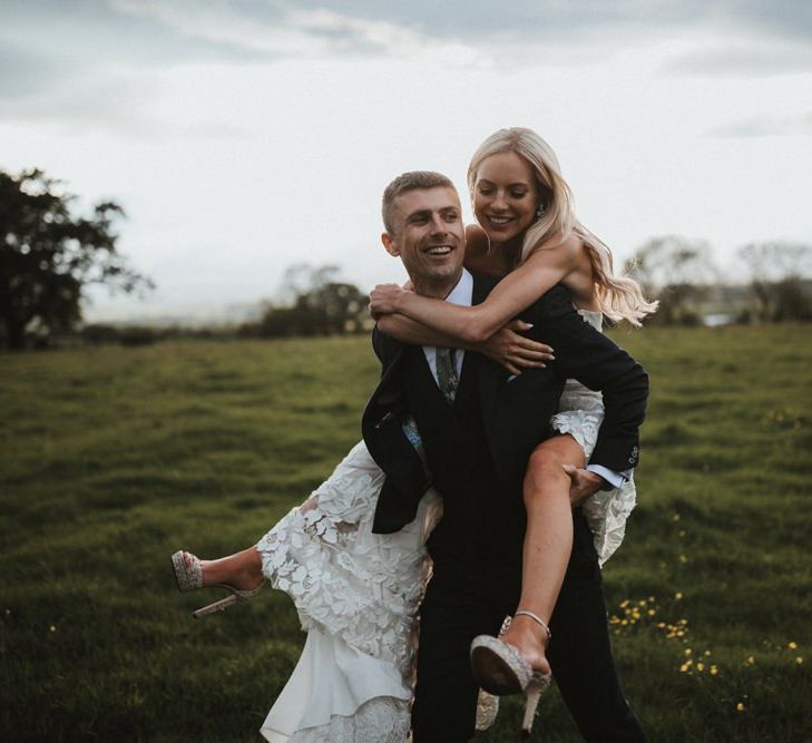 Groom Gives Piggyback To Bride Wearing Jimmy Choo Shoes