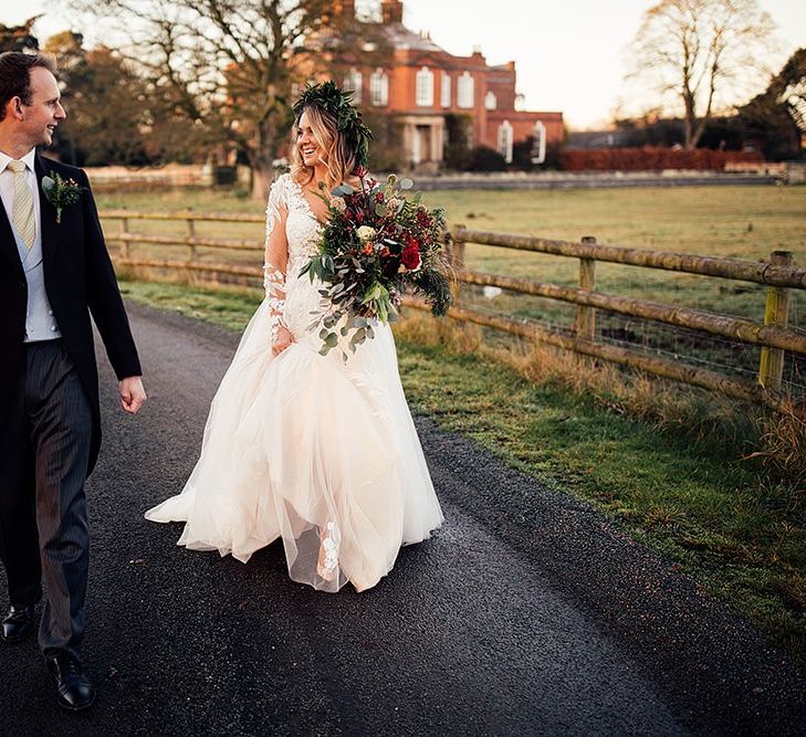 Bride in Riki Dalal wedding dress carries large bouquet