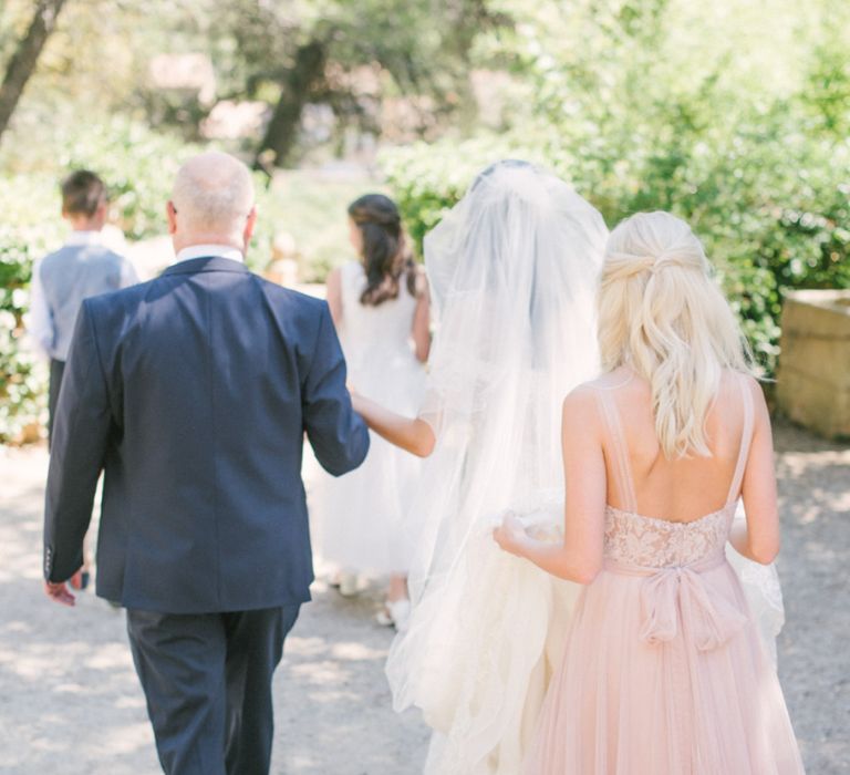 Bridal Party Walking To The Outdoor Wedding Ceremony