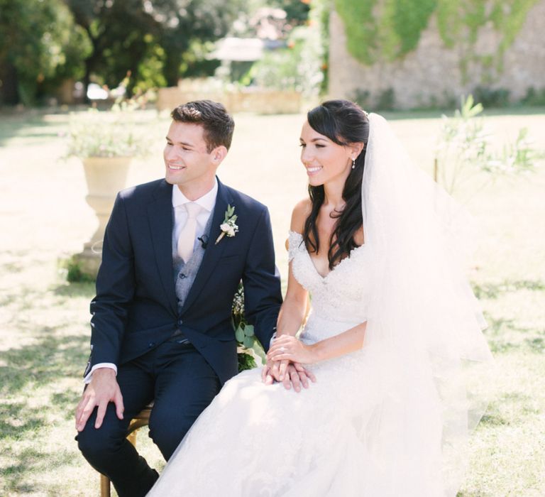 Outdoor Wedding Ceremony with Bride in Lace David Tutera Wedding Dress and Groom in Navy Three Piece Suit