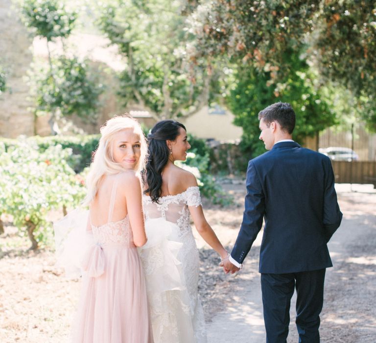 Bridesmaids in Dusky Pink Watters Bridesmaid Dress Holding the Brides  David Tutera Wedding Dress Train