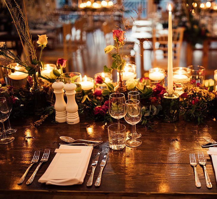 Cosy wedding table decor with candles and flowers