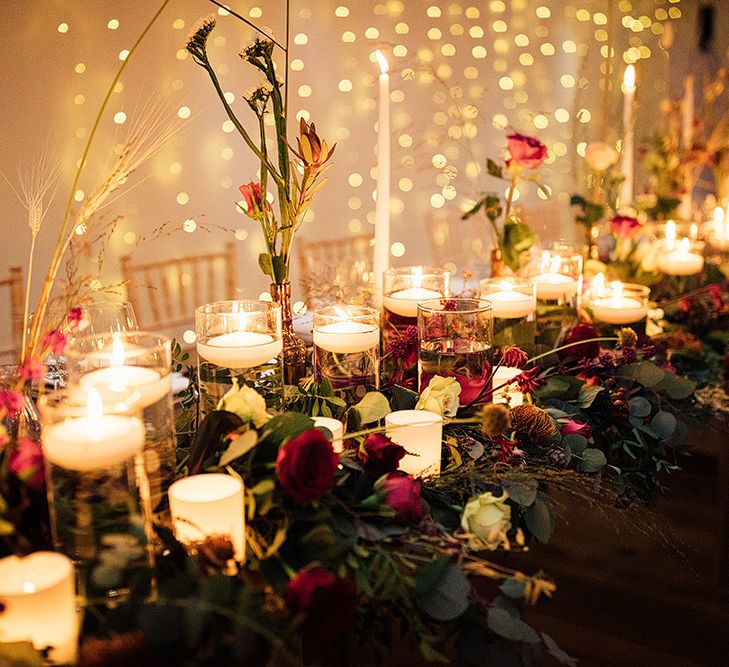 Cosy wedding table decor with candles and flowers