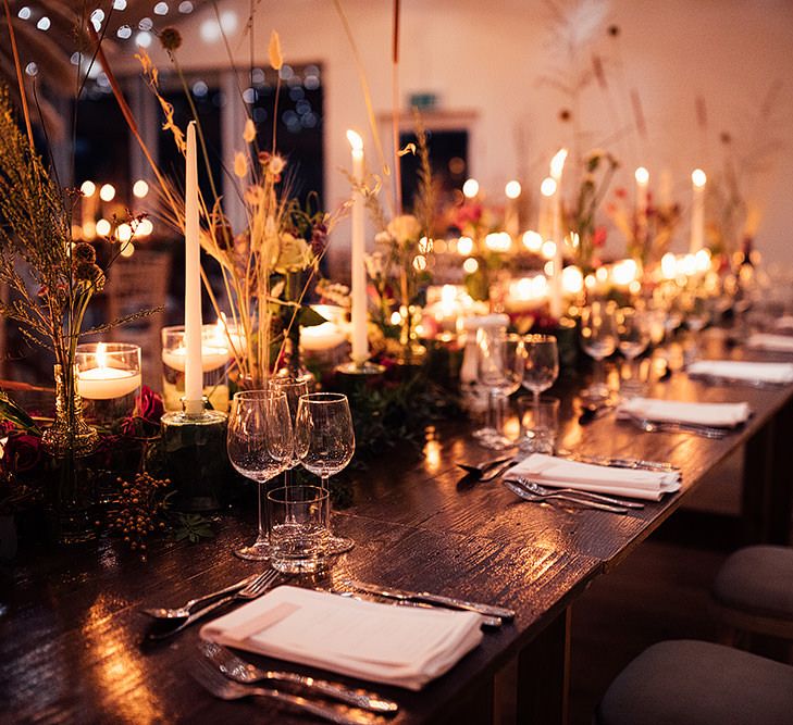 Cosy wedding table decor with candles and flowers