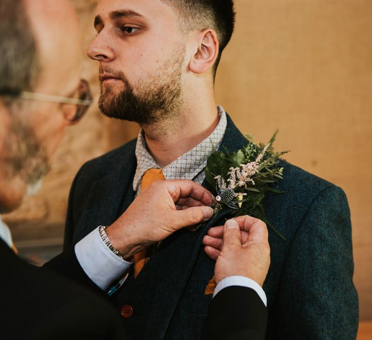 Groom preparations for rustic outdoor wedding