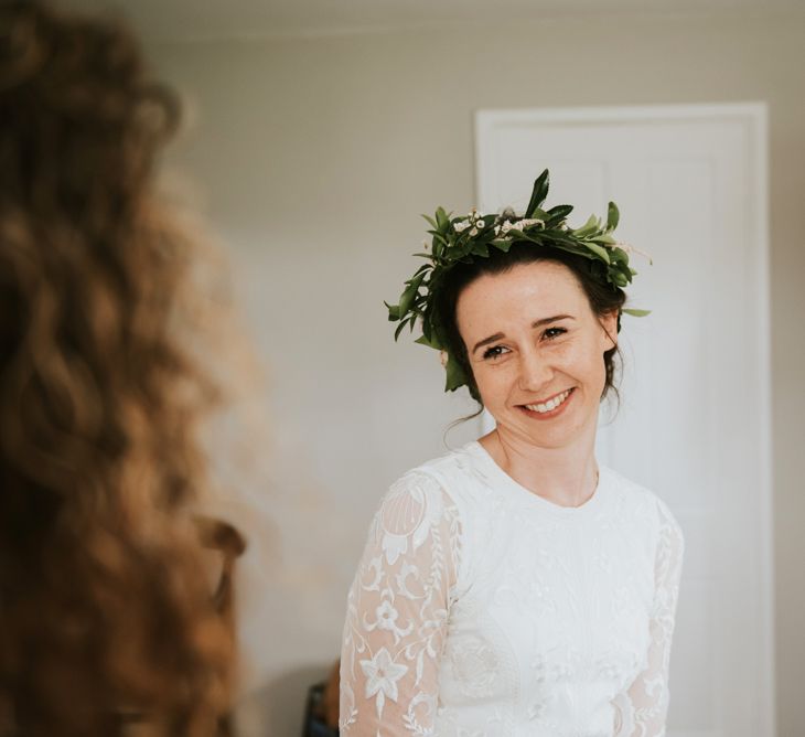 Bride in Savannah Miller wedding dress with foliage crown