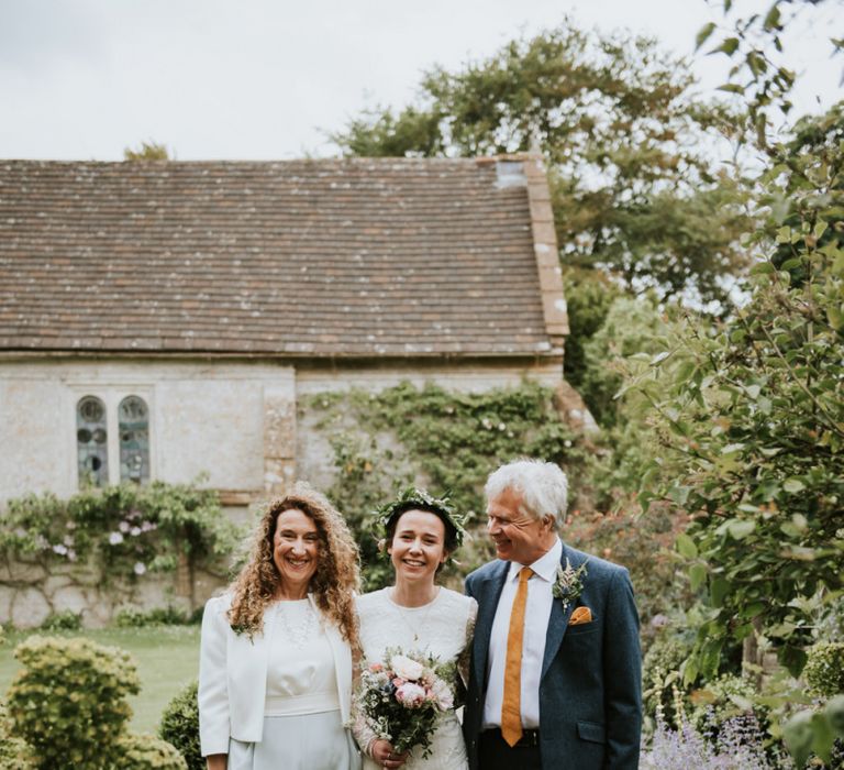 Bride with parents before ceremony