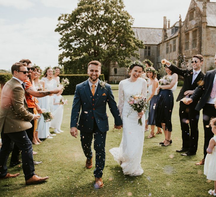 Confetti exit for bride wearing Savannah Miller wedding dress and groom