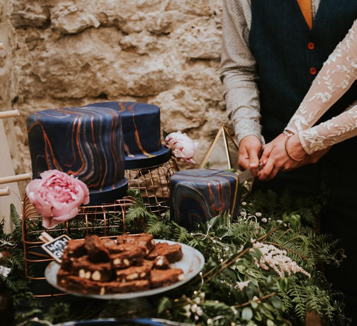 Bride and groom cut the space themed wedding cake