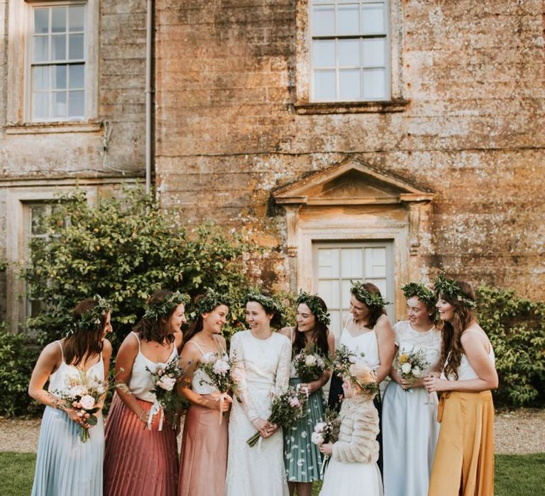 Bridal party in colourful midi skirts with bride in Savannah Miller wedding dress