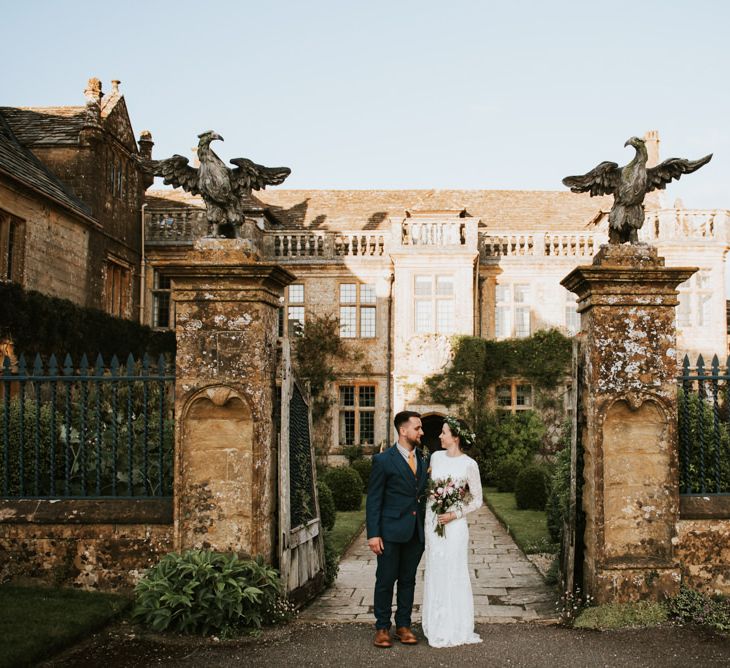 Bride and groom infront of Mapperton House with Savannah Miller wedding dress