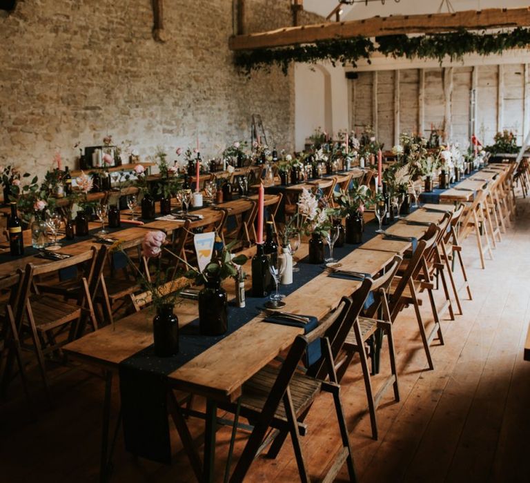 Wedding table decor with flower stems in glass bottles