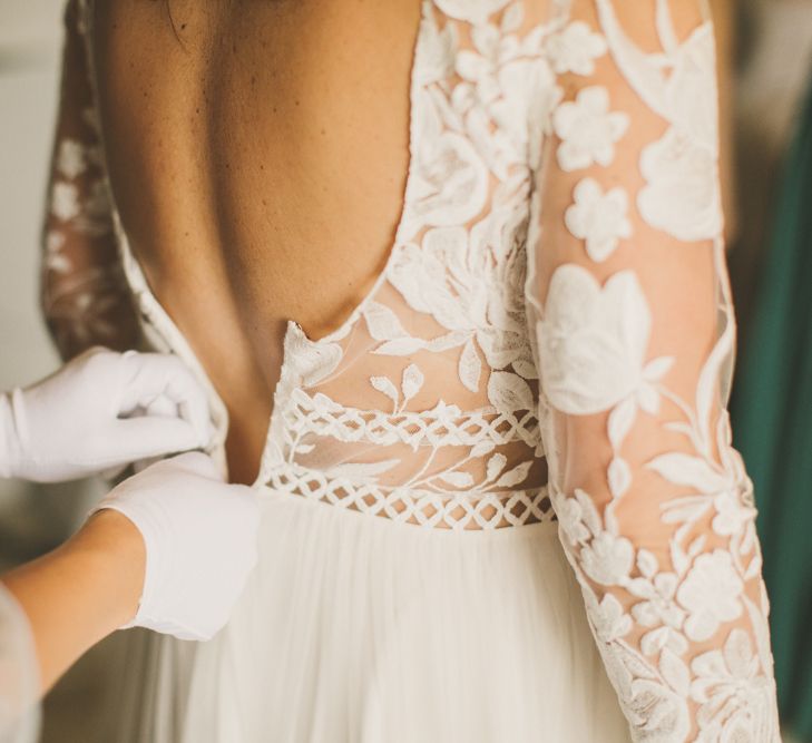 Lace wedding dress for rustic celebration with bright flowers and macrame table runner