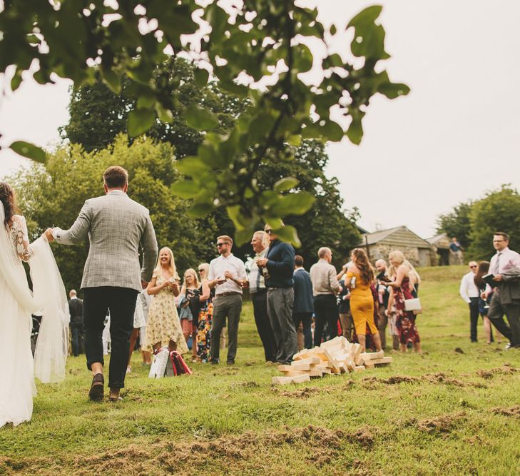 Bride and groom at rustic wedding with bouquet and macrame table runner