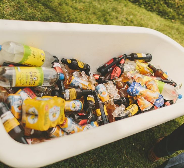 Booze bath at rustic wedding with macrame table runner and Prosecco station