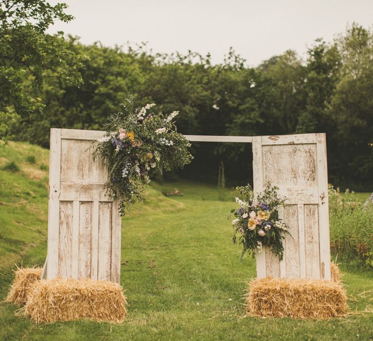 Homemade door arch at rustic wedding with macrame table runner