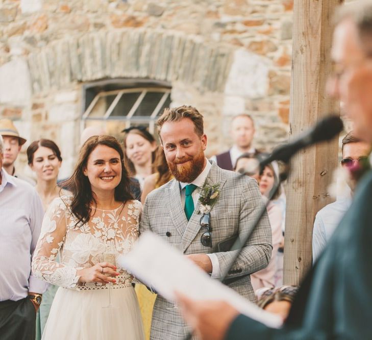 Bride and groom enjoy wedding speeches