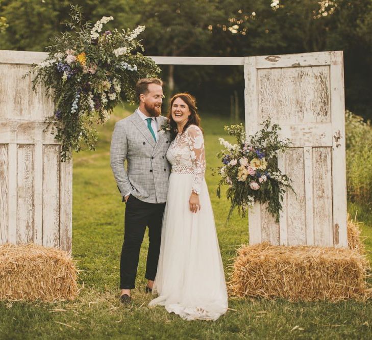 Homemade door arch at rustic wedding with macrame table runner