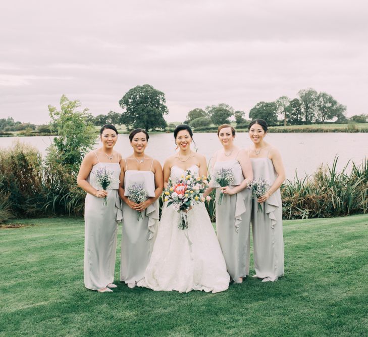 Bridal Party Portrait with Bride in Princess Wedding Dress and Bridesmaids in Grey Dresses