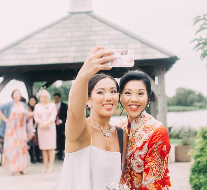 Selfie of Bride in Red Chinese Wedding Dress and Bridesmaid in Grey Dress