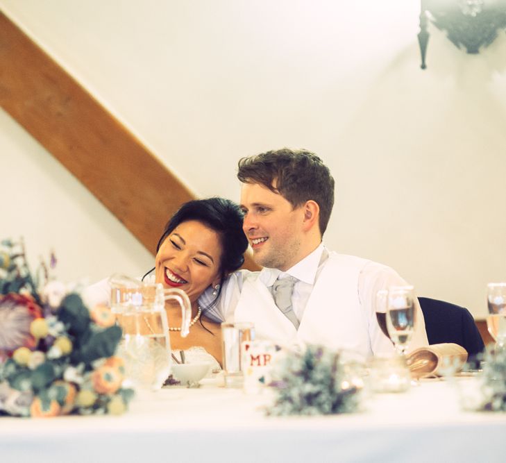 Bride and Groom Laughing During Wedding Reception Speeches