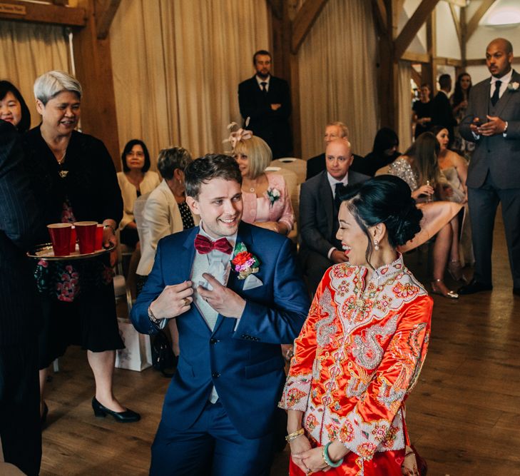 Chinese Tea ceremony with bride in red Chinese wedding dress and groom in tuxedo