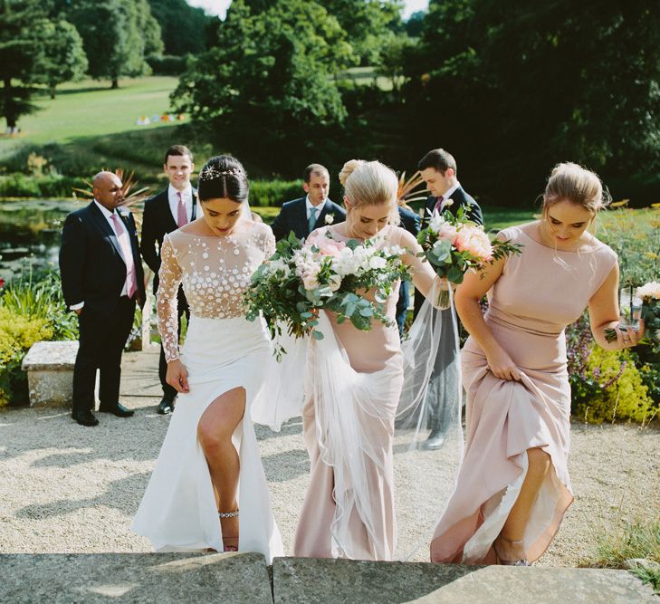 Bride in Rime Arodaky  Applique Long Sleeve Wedding Dress with Front Split and Bridesmaids in Pink Dresses