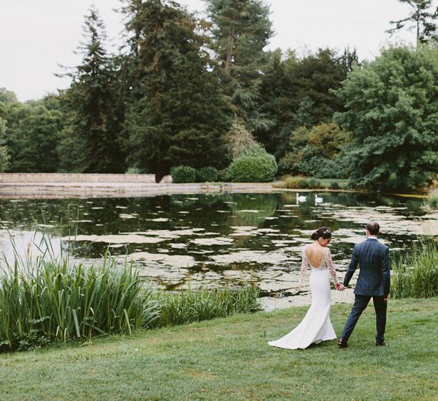 Bride in Applique Rime Arodaky Long Sleeve Wedding Dress and Groom in Dark Suit in Coley Manor Gardens