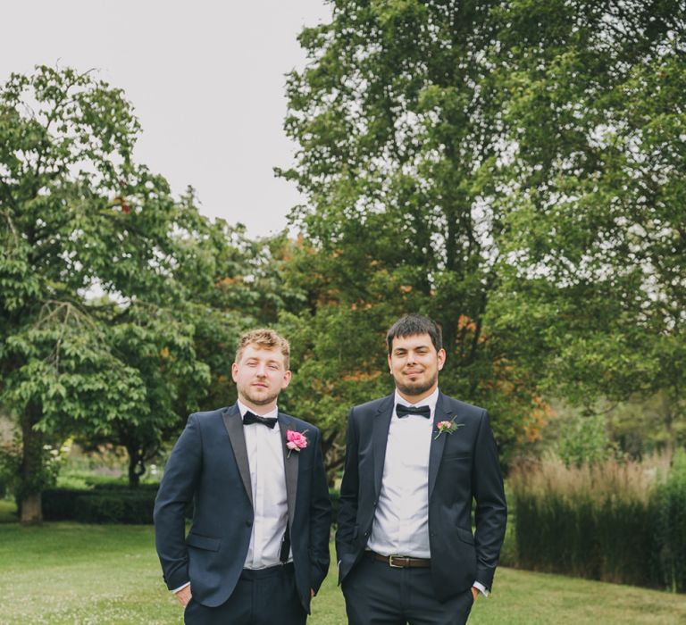 Groom in classic tuxedo wedding suit at conservatory wedding venue