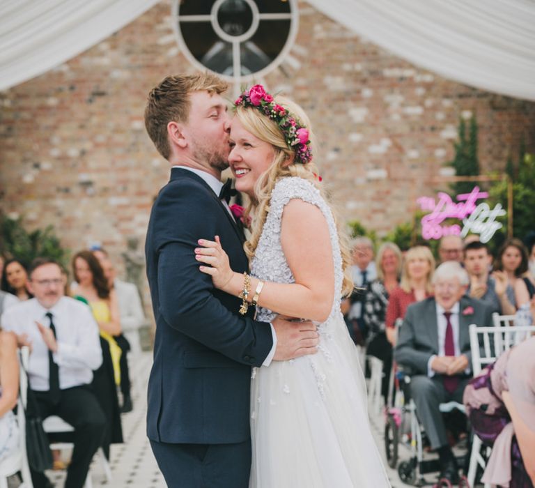 Bride and groom kiss at Hanbury Manor wedding ceremony