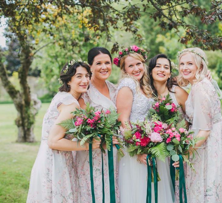 Bridal party in homemade bridesmaid dresses with pink bouquets