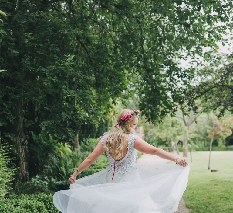 Bride in embellished wedding dress with pink flower crown