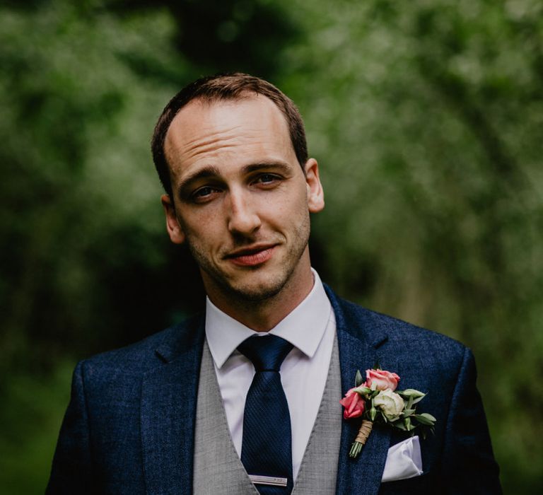 Groom in Navy Wedding Suit with Grey Waistcoat