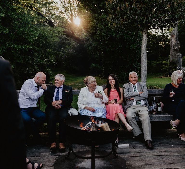 Wedding Guests Sitting Around the Outdoor Firepit