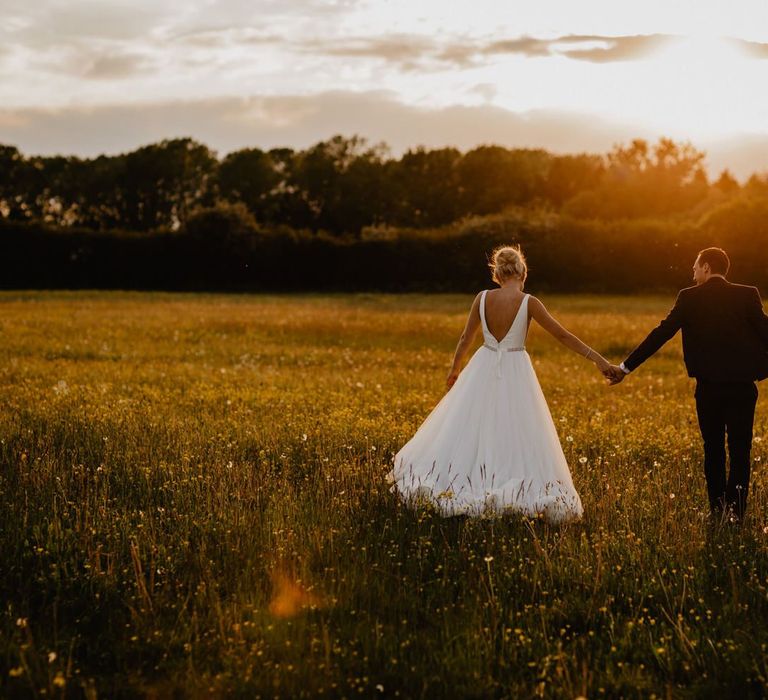 Golden Hour Portrait with Bride in Stella York Wedding Dress and Groom in Navy Suit