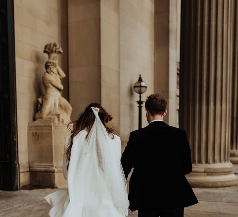 Bride and groom steal a moment at their informal December wedding in Liverpool