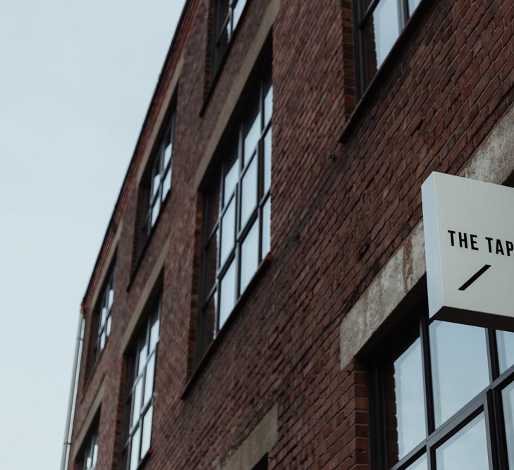 Party themed wedding reception at industrial style venue with bare brick walls