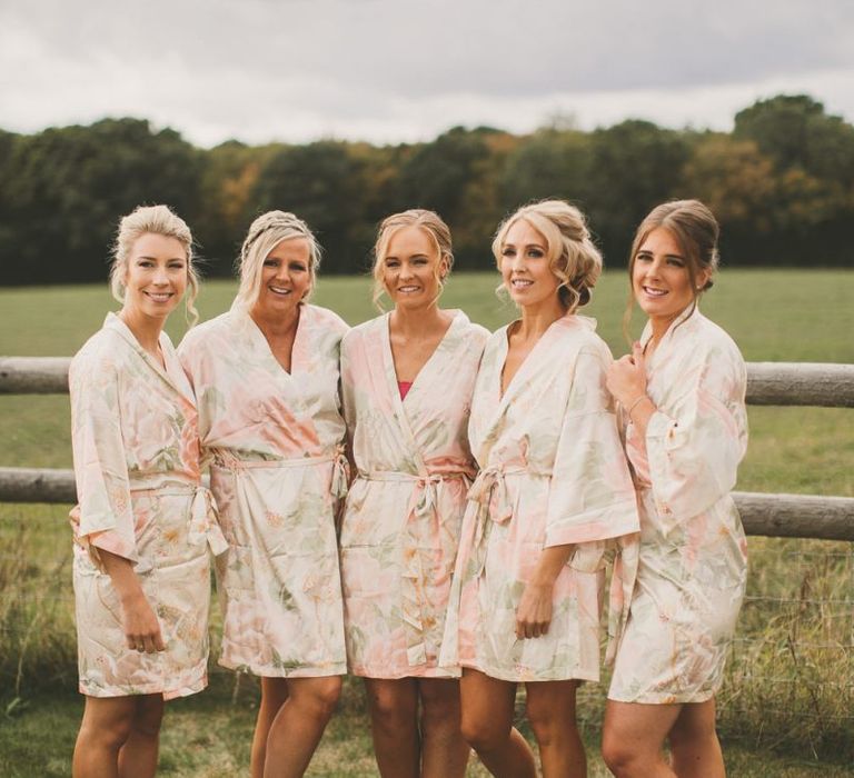 Bridesmaids in getting ready robes before getting changed into pale blue bridesmaid dresses