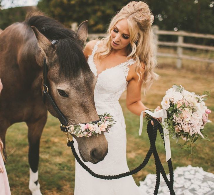 Bride with horse at wedding and blush bouquet