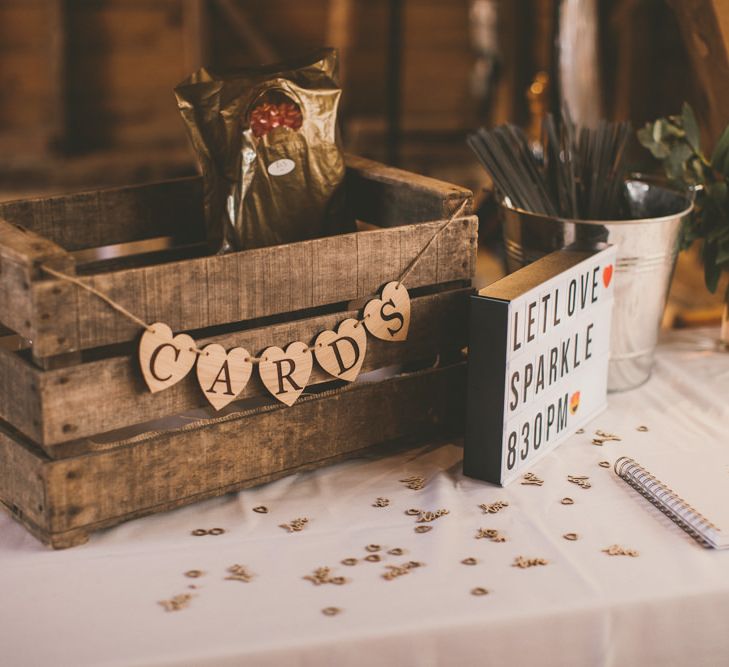 Rustic wooden crate card box at wedding with pale blue bridesmaid dresses