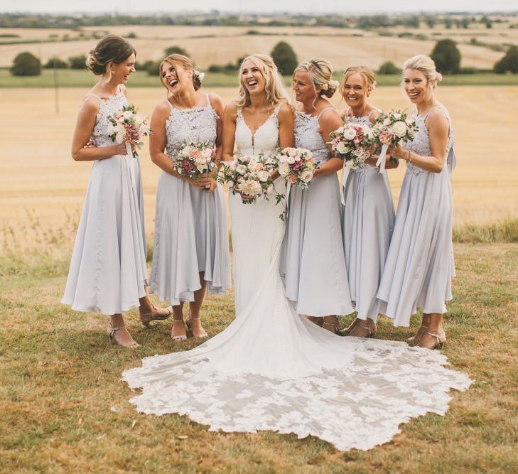 Pale blue bridesmaid dresses with blush wedding bouquets