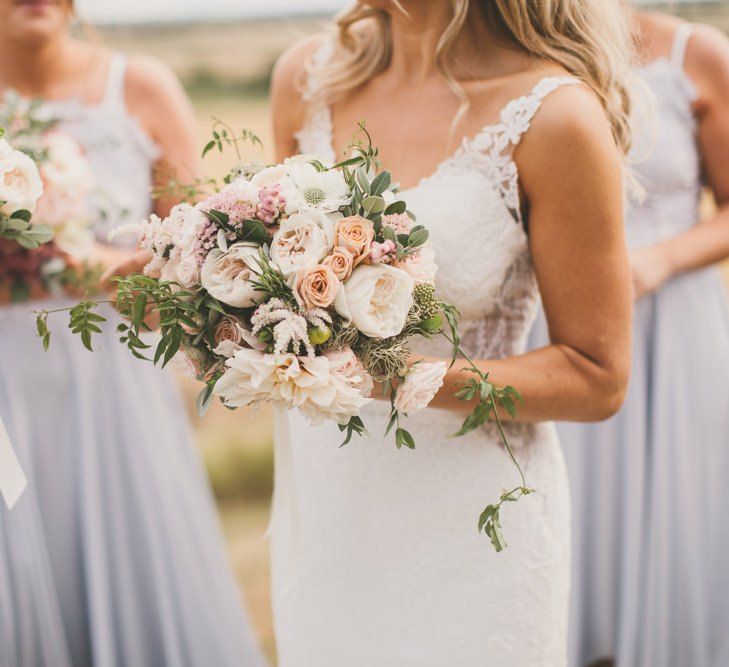 Pale blue bridesmaid dresses with blush wedding bouquets