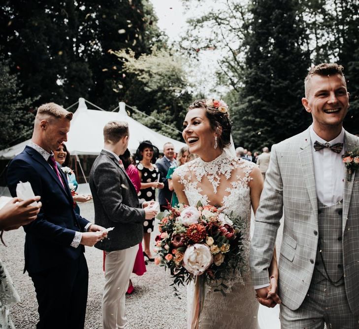 Confetti Shot with Sleeveless Wedding Dress and Grey Check Suit