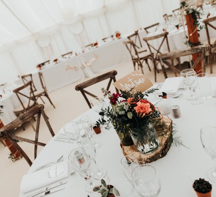 Bright Floral Table Arrangements in Marquee Wedding