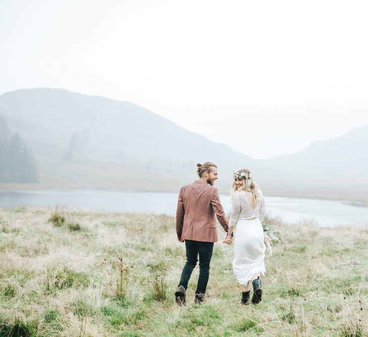 Boho Bride and Groom Holding Hands in the Lake District