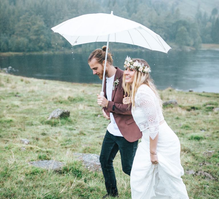 Bride and Groom Under a White Umbrella in the Lake District