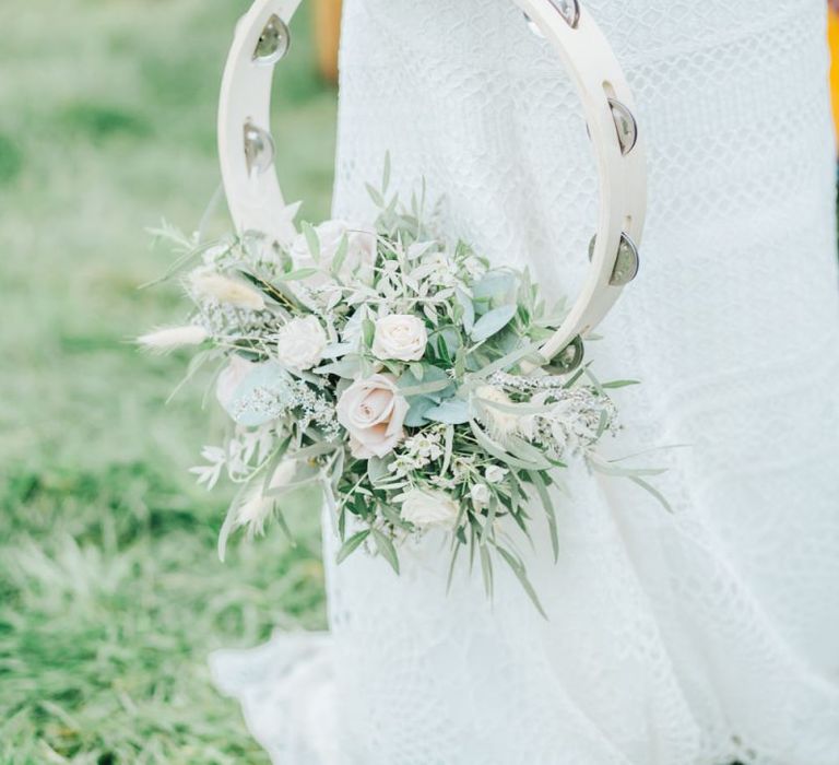 Boho Bride in Crochet Skirt Holding a  Tamborine Covered in Flowers