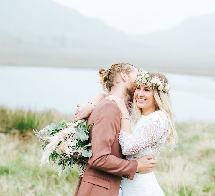 Groom with Top Knot Kissing His Brides Head