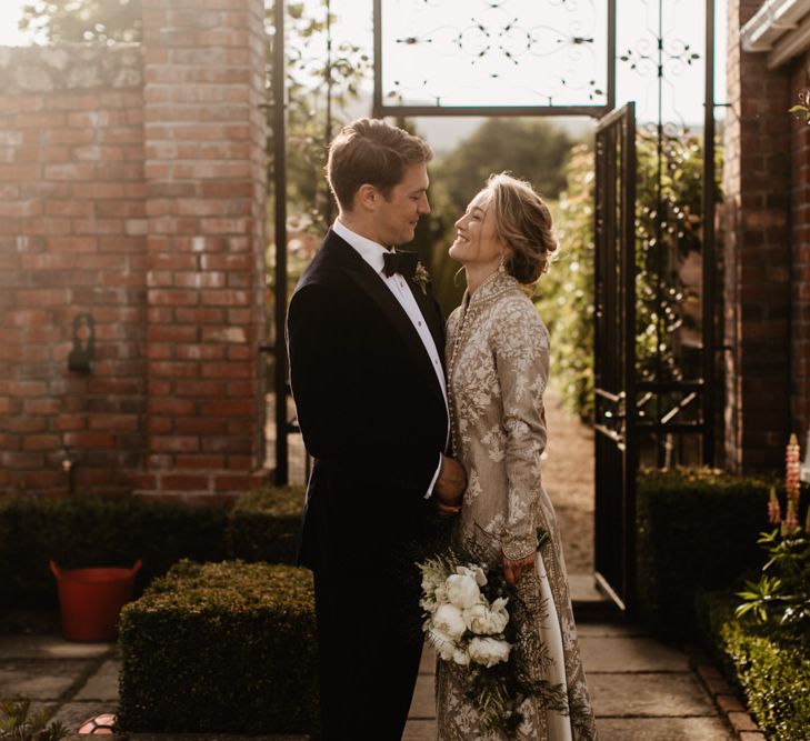 Groom In Tux and Bride In Indian Inspired Bridal Coat