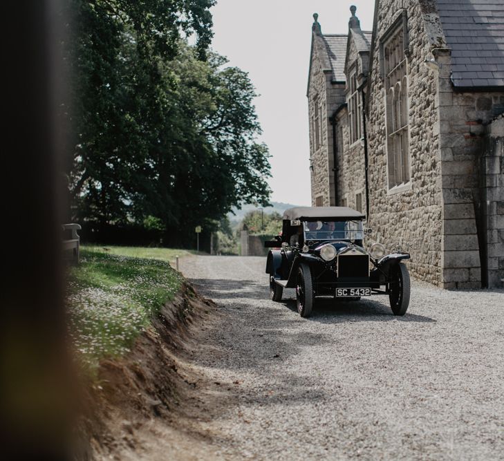 Vintage Car Pulling Up To Church With Bride In For Ceremony